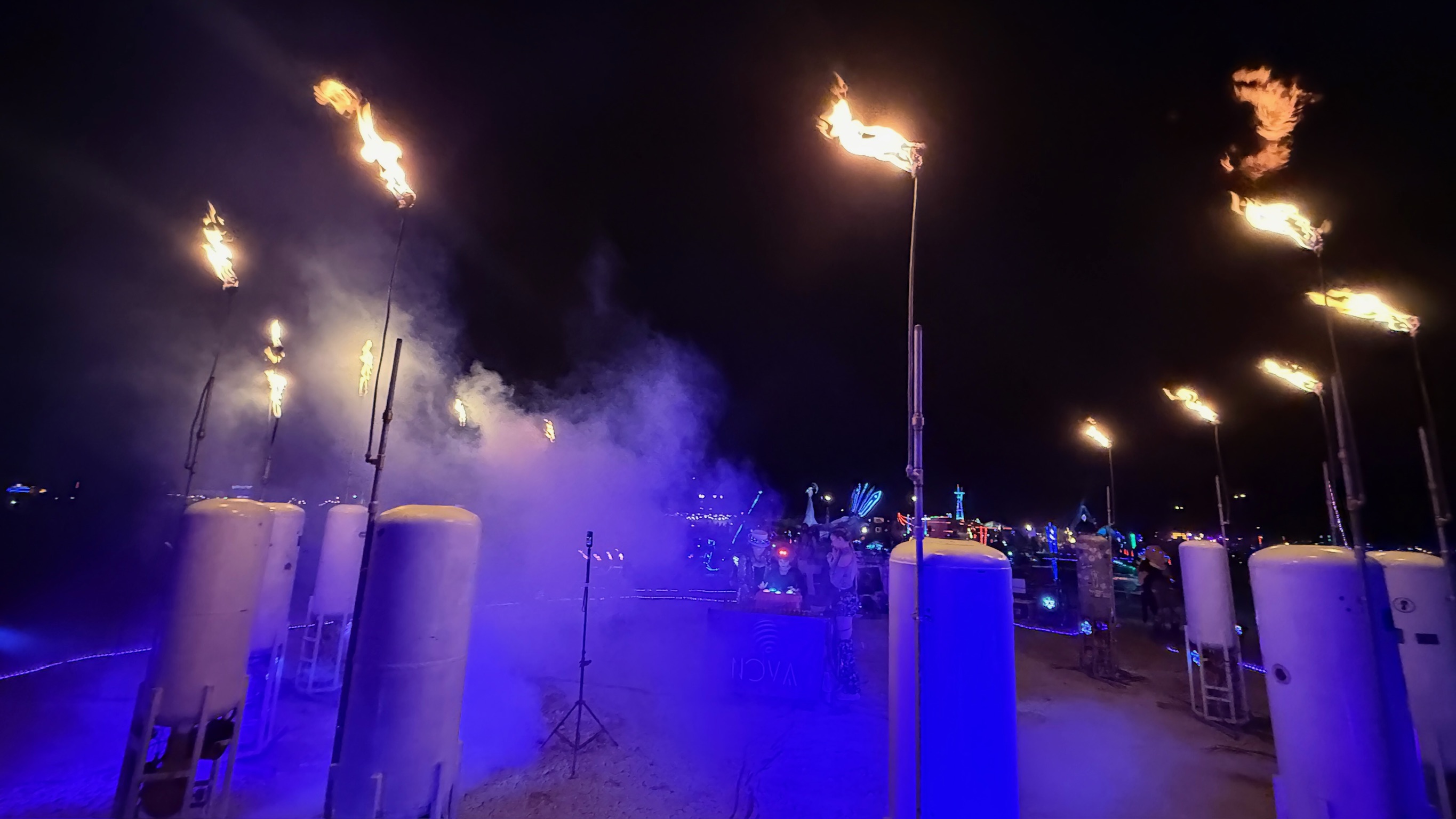 Spectators gathered at Nova installation experiencing the moment together as flames erupt and smoke rises